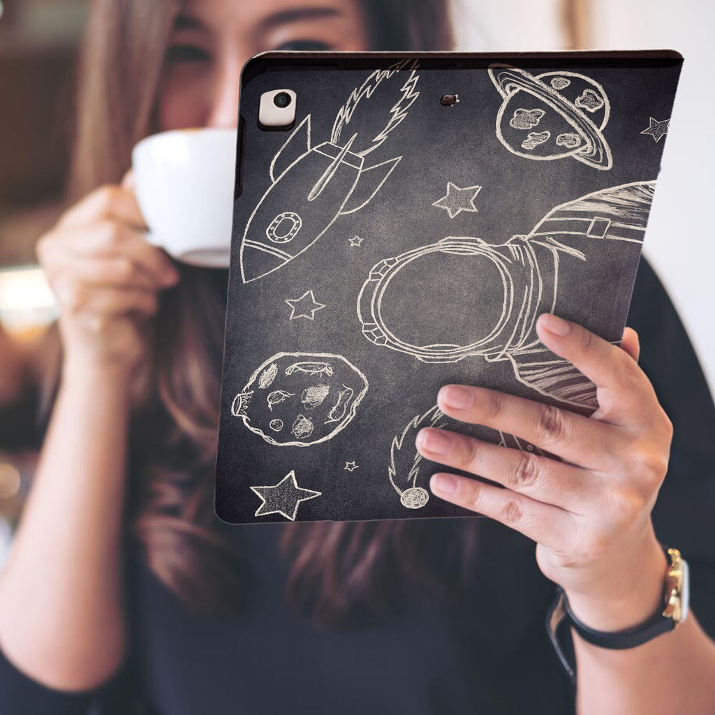 a girl is holding and viewing personalized iPad folio case with Astronaut Space design