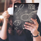 a girl is holding and viewing personalized iPad folio case with Astronaut Space design