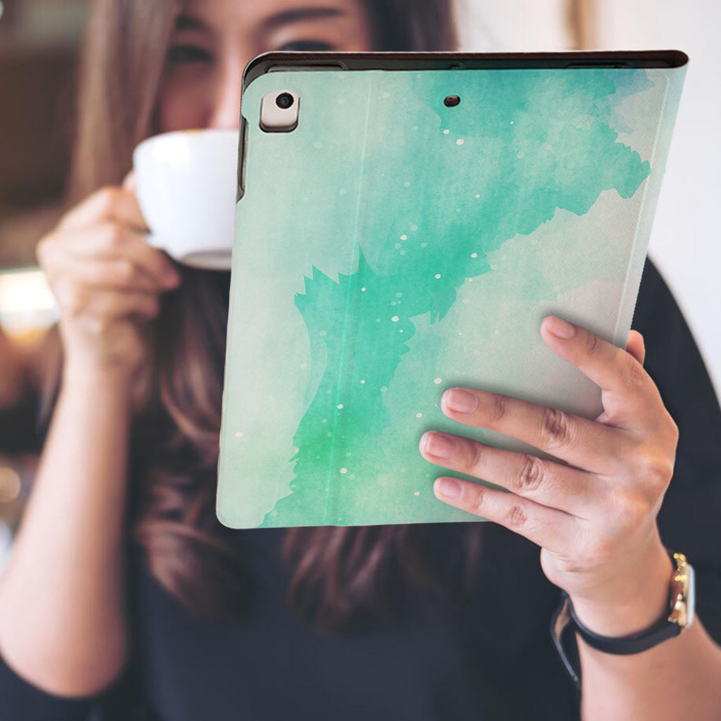 a girl is holding and viewing personalized iPad folio case with Abstract Watercolor Splash design
